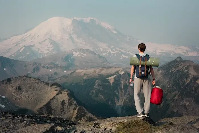 View of a man on top of a hike with his packed items