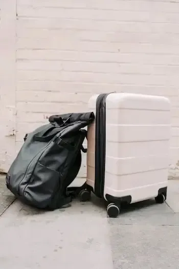 A carry on bag and a large suitcase
